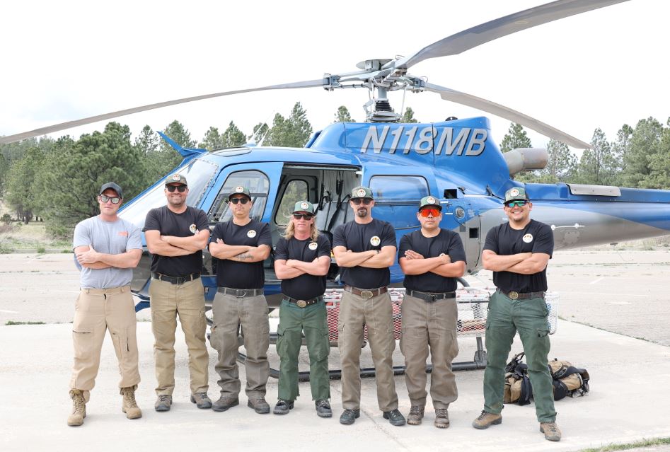 The Vulcan Peak Helitack Crew posing in front of a helicopter.